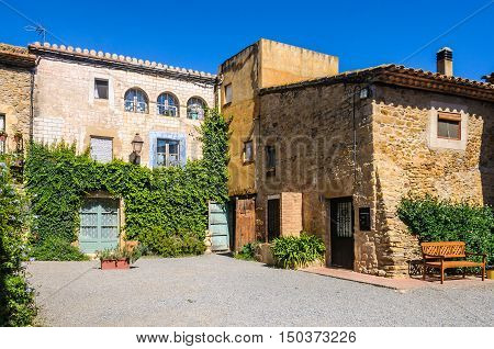 PERATALLADA, SPAIN - SEPTEMBER 26, 2015: Charming small square in Peratallada village in Catalonia Spain