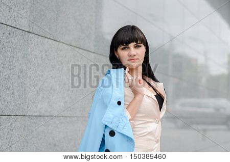Long-haired Brunette In A White Suite With A Turquoise Coat