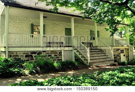 New York City - June 29 2010: West front with staircase and porch at 1784 Dyckman Farmhouse Museum Manhattan's last Dutch colonial farmhouse