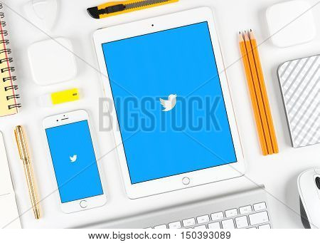 Moscow, Russia - October 04, 2016: Twitter application on display of iPad and iPhone. Twitter is popular social network service application