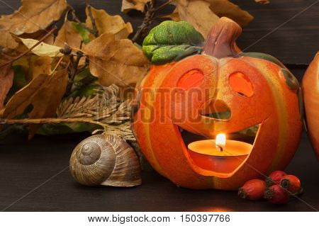 Halloween pumpkin party, Big terrible Pumpkin lighten and reflection on wooden table background. Halloween pumpkin with scary face. Place for your text.