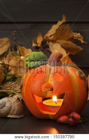 Halloween pumpkin party, Big terrible Pumpkin lighten and reflection on wooden table background. Halloween pumpkin with scary face. Place for your text.