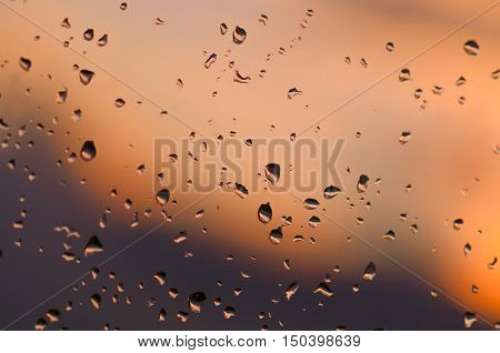 On the glass drops of water with gradient background.