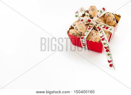 Mini Christstollen in a festive red tray decorated with ribbon isolated on white background. Lots of copy space.