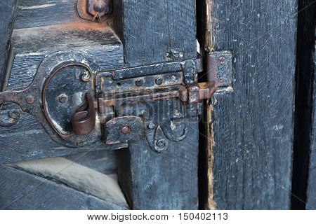 iron lock - heck close up on old wooden closed door