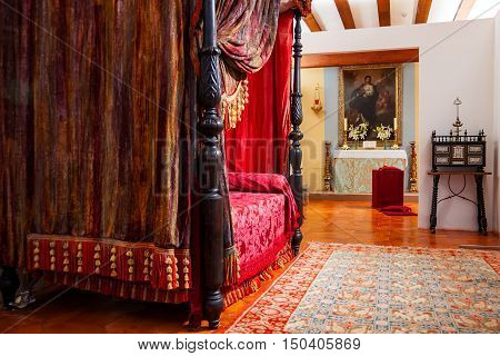MANZANARES EL REAL SPAIN - JULY 12 2012: Interiors of Mendoza Castle. Bedroom with medieval decoration.
