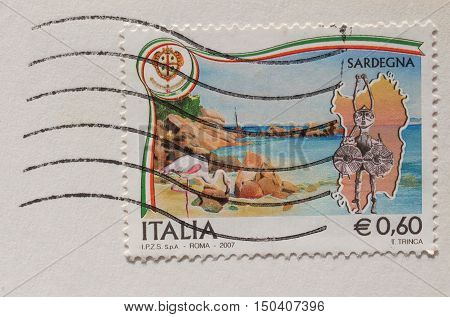 CAGLIARI SARDINIAITALY - CIRCA JANUARY 2014: A stamp printed in Italy reading Sardegna (meaning Sardinia) about Sardinian folk masks with postage meter