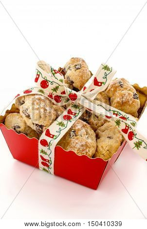 Closeup of Mini Christstollen in a festive red tray decorated with ribbon isolated on white background. Lots of copy space.