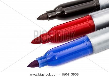 Three felt-tip pens markers highlighters close-up isolated on white background