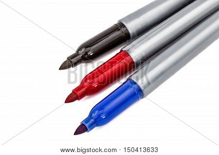 Three felt-tip pens markers highlighters close-up isolated on white background