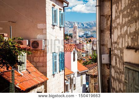 Street of Old Town Split in Dalmatia region, Croatia. Medieval Houses with Red Roofs. Popular Tourist Destination at Adriatic Sea. Mediterranean Europe Travel Concept.