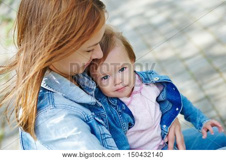 beautiful young mother with a baby summer day outdoors