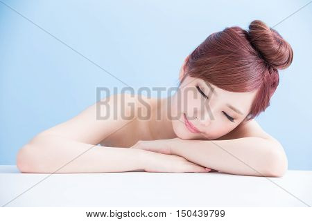 Charming woman face Smile enjoy spa and massage while lying isolated on blue background asian girl