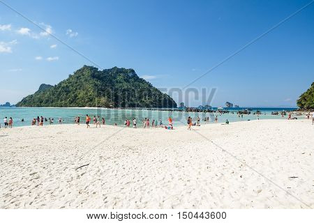 Tourists on a white sand beach in Krabi, Thailand