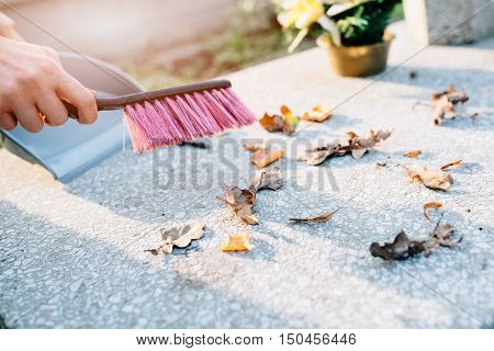 A Woman Cleans The Grave
