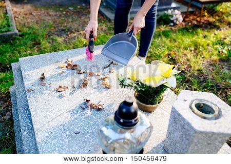A Woman Cleans The Grave