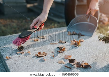 A Woman Cleans The Grave