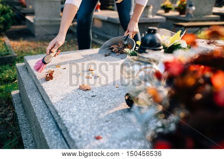 A Woman Cleans The Grave
