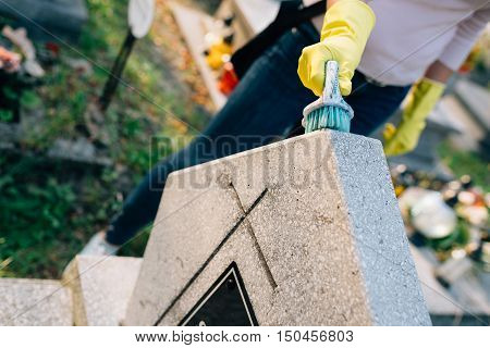 A Woman Cleans The Grave.