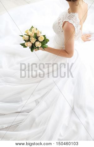 Bride in beautiful dress with wedding bouquet