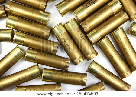 A pile of shotgun cartridges on a white background