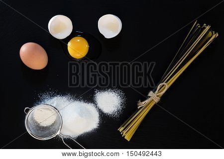 Traditional And Black Uncooked Italian Pasta Linguine With White And Brown Chicken Eggs