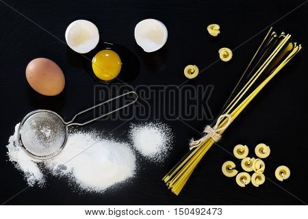 Traditional And Black Uncooked Italian Pasta Linguine With White And Brown Chicken Eggs
