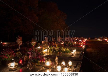 Tvrdomestice, Slovakia - 2.11.2015: Votive Candles Lantern Burning On Graves In Cemetery At Night Ti