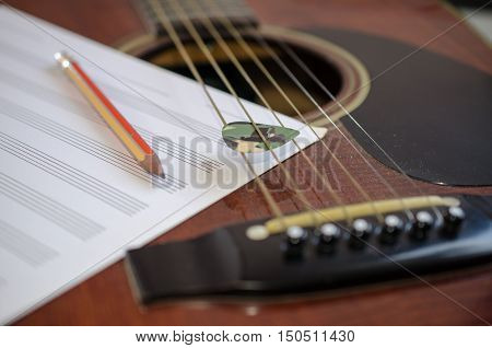 Composer tool. Guitar guitar pick an eraser a pencil.