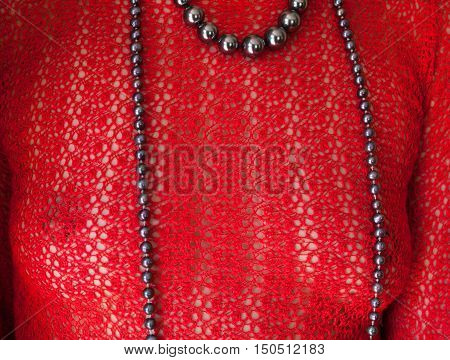 Sexy woman in the red see-through blouse and long necklace.