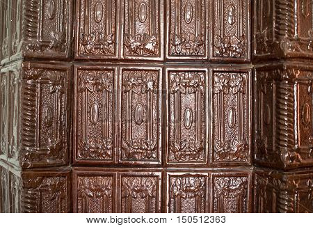 Brown tiles on the stove surface. Close up.