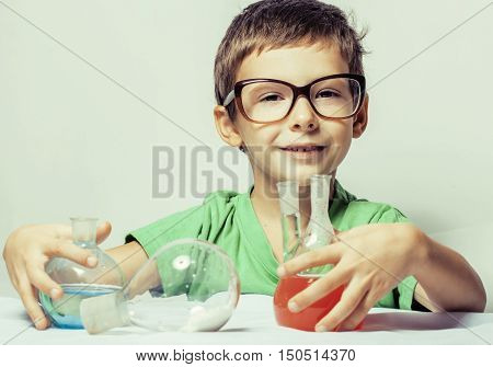 little cute boy with medicine glass isolated wearing glasses smiling, small genious, lifestyle people concept close up