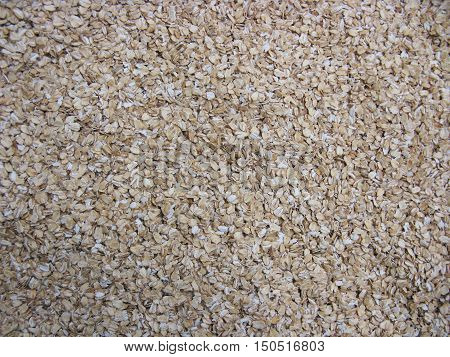Dry cereal (rolled oats, oatmeal, oat flakes). Oatmeal background. Natural background. Food background.