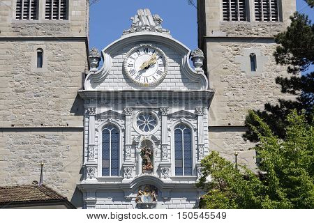 LUCERNE SWITZERLAND - MAY 06 2016: The clock is placed above the main entrance of Church of St. Leodegar that was built from 1633 to 1639. The towers made of stone can be seen on the both sides.