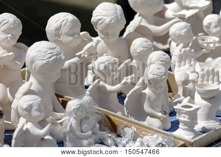 EINSIEDELN SWITZERLAND - MAY 09 2016: Figurines of Various White Angels put on sale at a religious souvenir store. This shop can be seen in front of Benedictine Abbey of Einsiedeln.