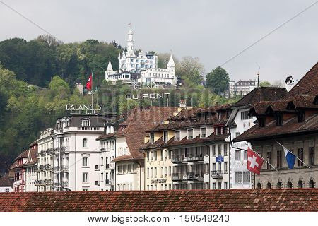 LUCERNE SWITZERLAND - MAY 04 2016: Gutsch castle with its hotel and restaurant towering over the city buildings. It shows the variety of sightseeing attractions