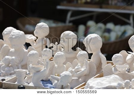 EINSIEDELN SWITZERLAND - MAY 09 2016: Various White Angels put on sale at a religious souvenir store. Those figurines can be seen in a shop placed in front of Benedictine Abbey of Einsiedeln