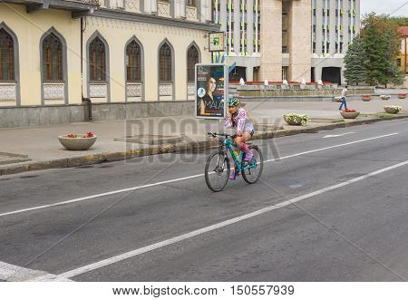 DNEPR, UKRAINE - AUGUST 24, 2016: Lonely cyclist on Yavornytskyi Avenue at summer weekend in Dnepr city Ukraine at August 24, 2016