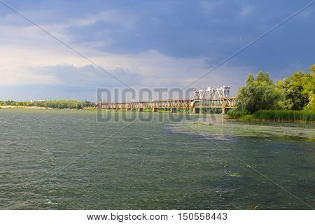 Bridge across river Dnieper in Kremenchug and storm clouds in sky