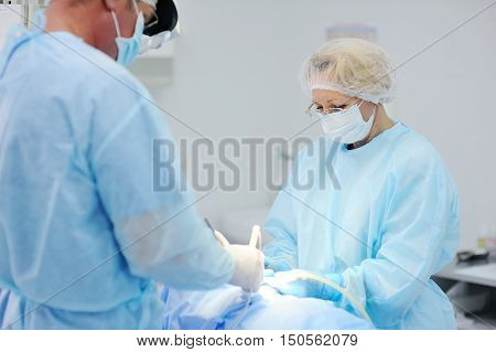surgeons operate on a patient in the background Surgical Lamp
