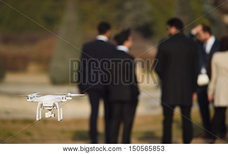 Drone recording the busienessman meeting in park