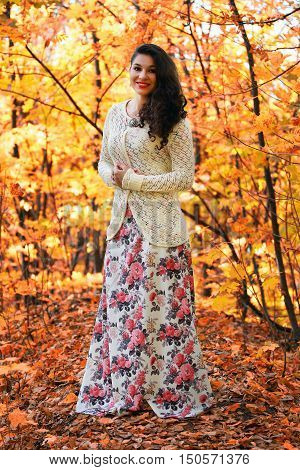 portrait of a beautiful girl with maple yellow leaves