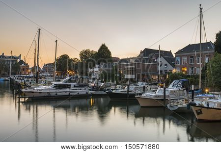 Dordrecht The Netherlands - September 13 2016: Harbor of Dordrecht Zuid-Holland The Netherlands with yachts and sail boats in evening light.