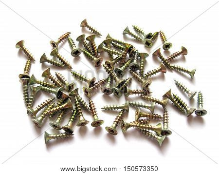 Screws isolated on white background. Screws on white background. Scattered screws. Construction and repair.