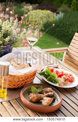 Summer lunch with grilled chicken in the garden.