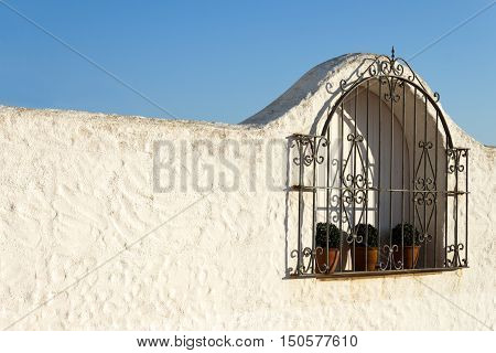 Typical spanish grated window in a white wall house. Roc de Sant Gaieta Tarragona Catalunya Spain.