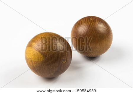 pair of wooden Chinese singing balls Baoding of health for hands on white background
