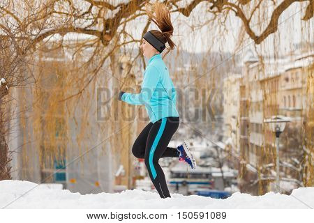 Fit Woman Running Through Park.