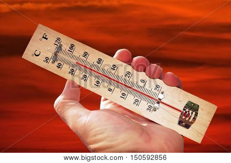 A hand and temperature scale over a red sky shows high temperatures during a heat wave.
