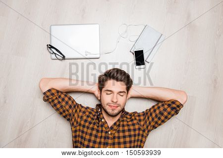 Portrait Of Young Calm Man Lying On Floor And Sleping
